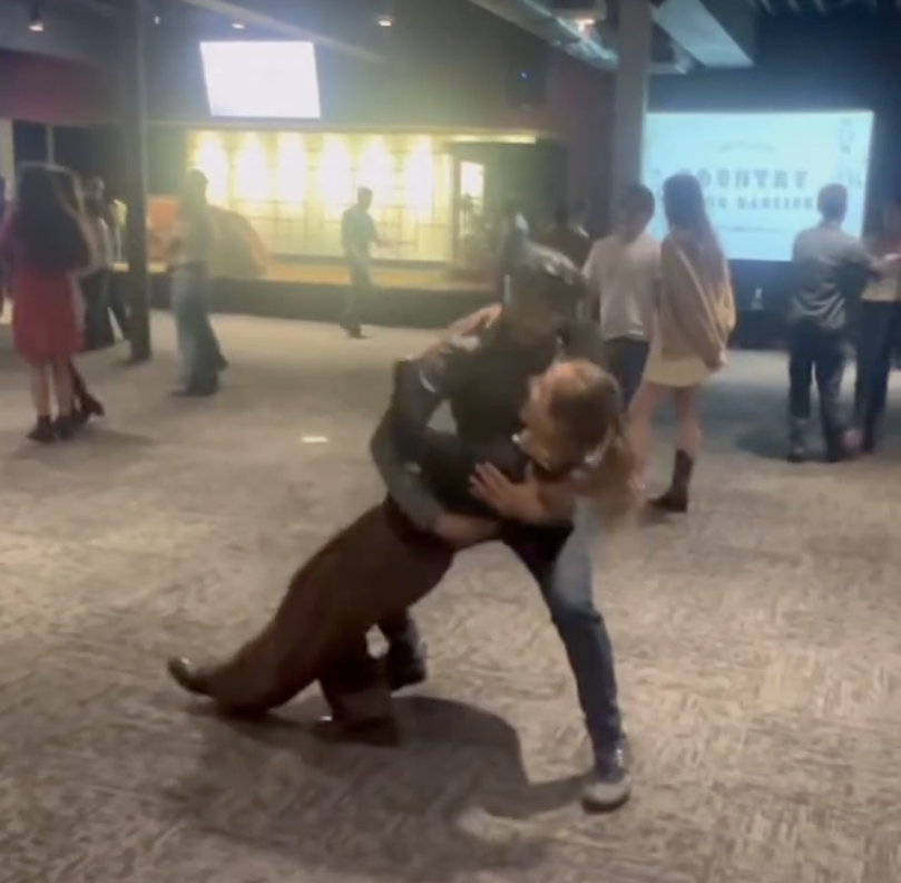 Joshua swing dancing with a partner mid-dip